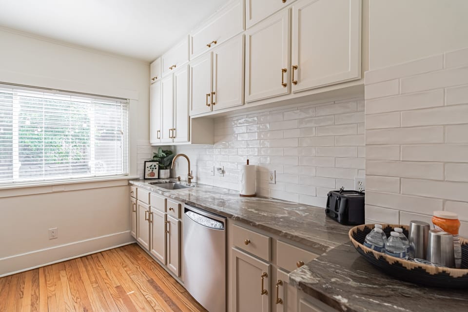 Full kitchen looks into fenced in backyard!