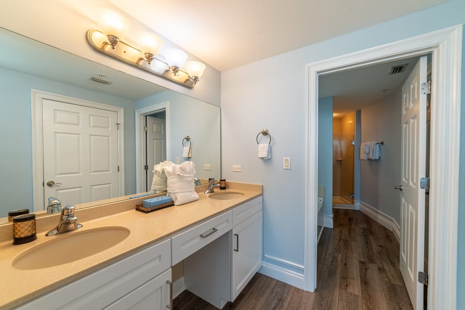 En suite master bath with double vanities, garden tub, and walk-in shower
