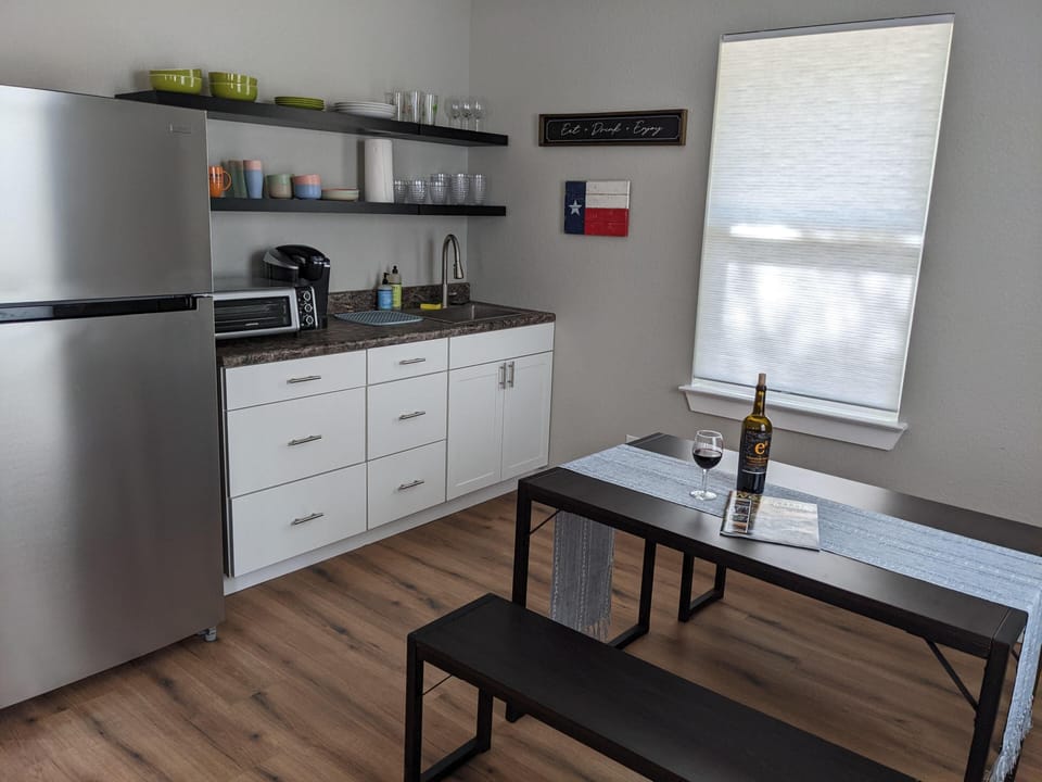 With portable induction cooktop, fridge, freezer, coffee, toaster oven.