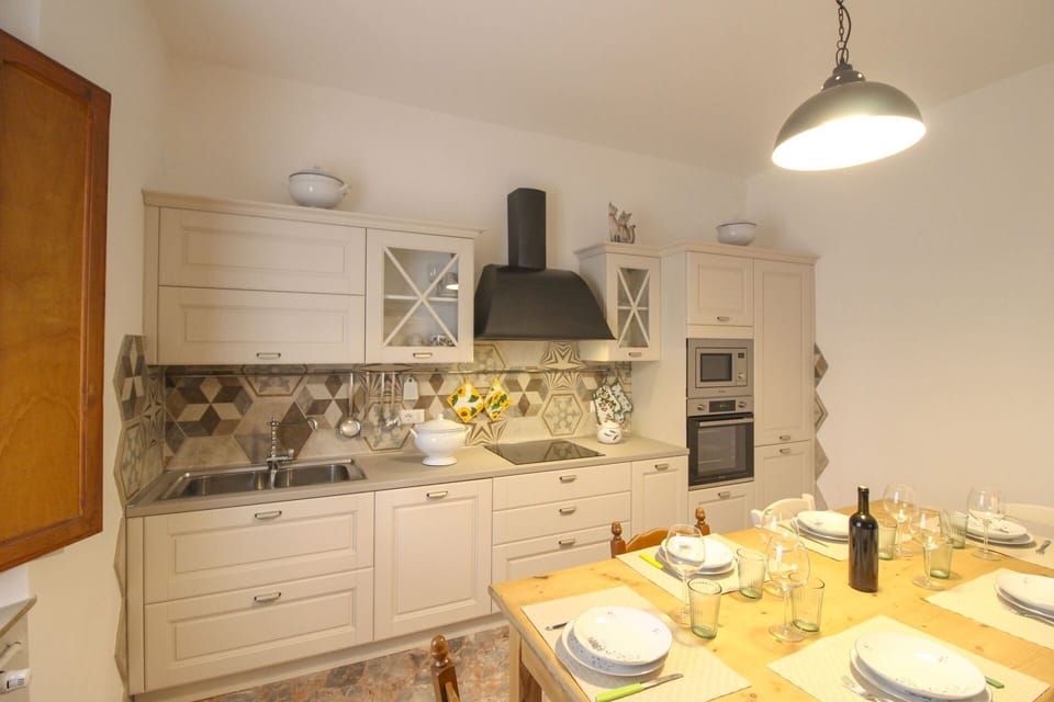 Furniture, Interior Design, Flooring, Kitchen, Wood, Floor, Countertop, Ceiling, Light Fixture, Room