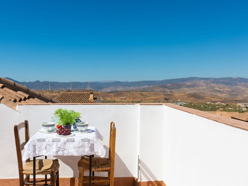 Sky, Furniture, Table, Chair, Building, Plant, Wood, Outdoor Furniture, Mountain, Outdoor Table