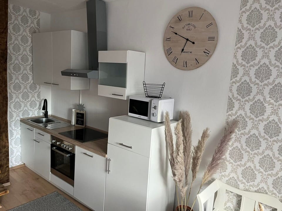 Furniture, Cabinetry, Countertop, Sink, Kitchen Stove, Wood, Interior Design, Clock, Shelving