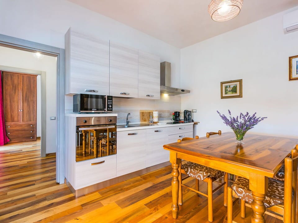 Table, Furniture, Property, Cabinetry, Wood, Interior Design, Floor, Flooring, Flower, Living Room