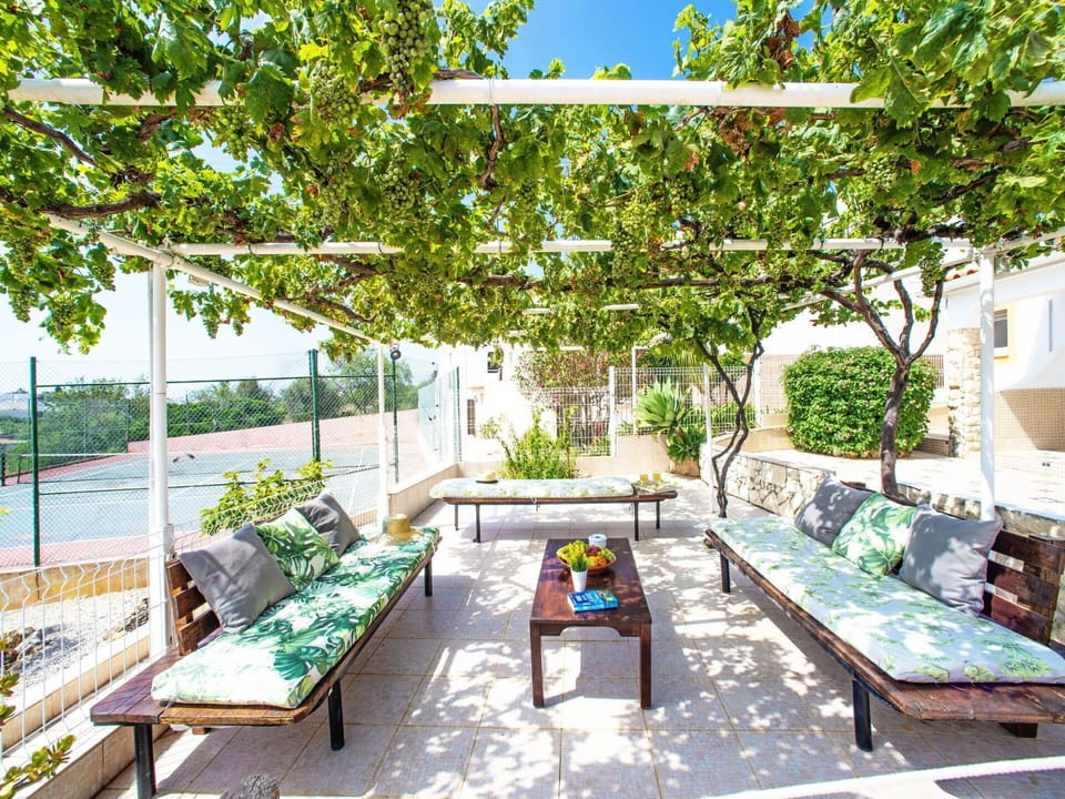 Plant, Shade, Outdoor Furniture, Botany, Outdoor Bench, Tree, Urban Design, Building, Real Estate, Leisure