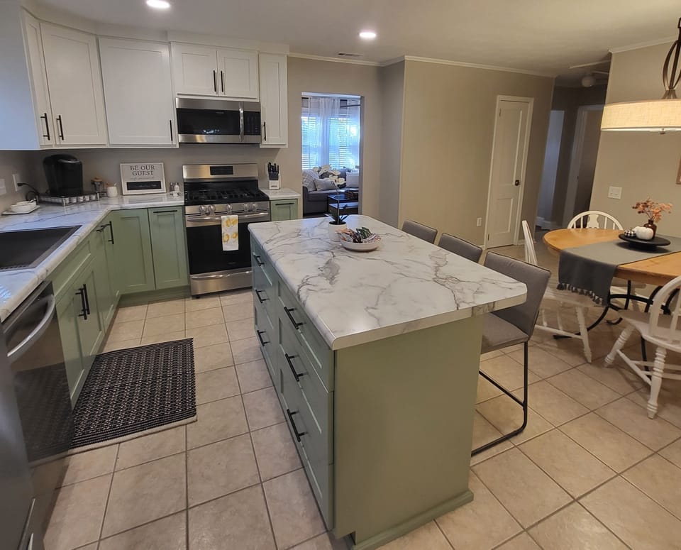 New kitchen, well stocked! Gas stove w/child proof covers on knobs.