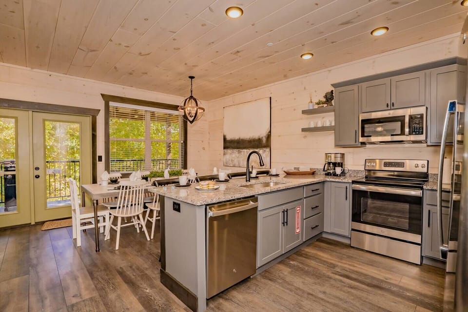Kitchen: Modern design meets nature with scenic views and stylish dining for unforgettable meals!