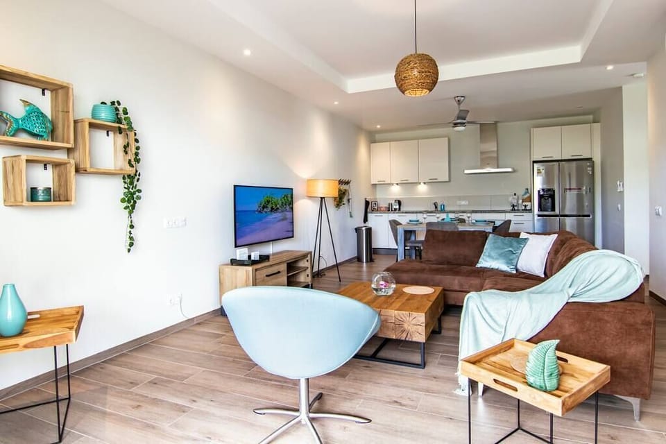 Lounge set with 50 inch smart TV in the living room with open kitchen. (2)