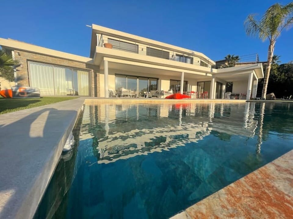 infinity pool and villa at the back