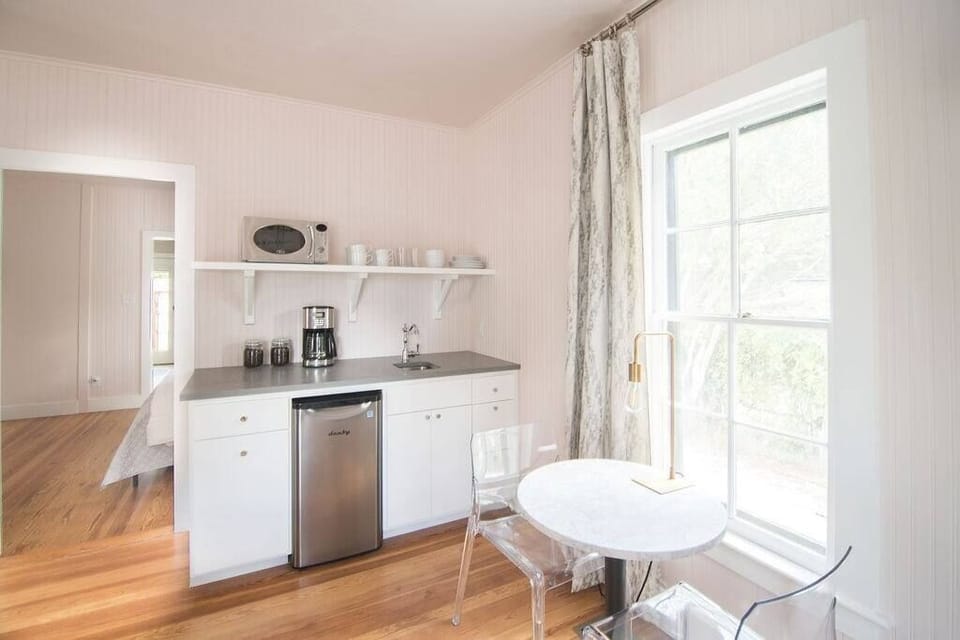 Kitchenette with mini fridge, microwave, coffee maker and dishes