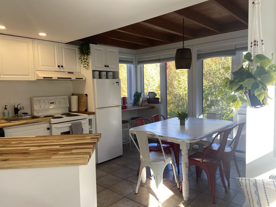 Open concept living space with kitchen, dining area and living room