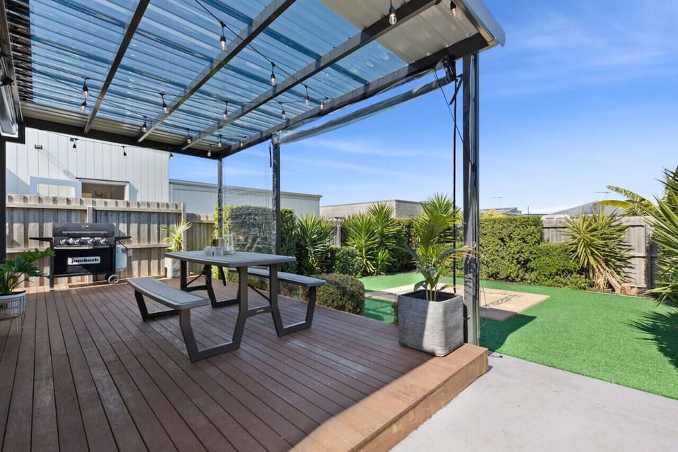 🌿 Spacious alfresco deck with BBQ, outdoor seating, and year-round use