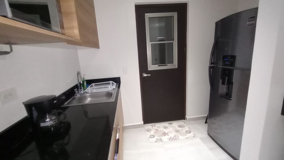 Fridge, coffee maker, pots and pans cooking and eating utensils.