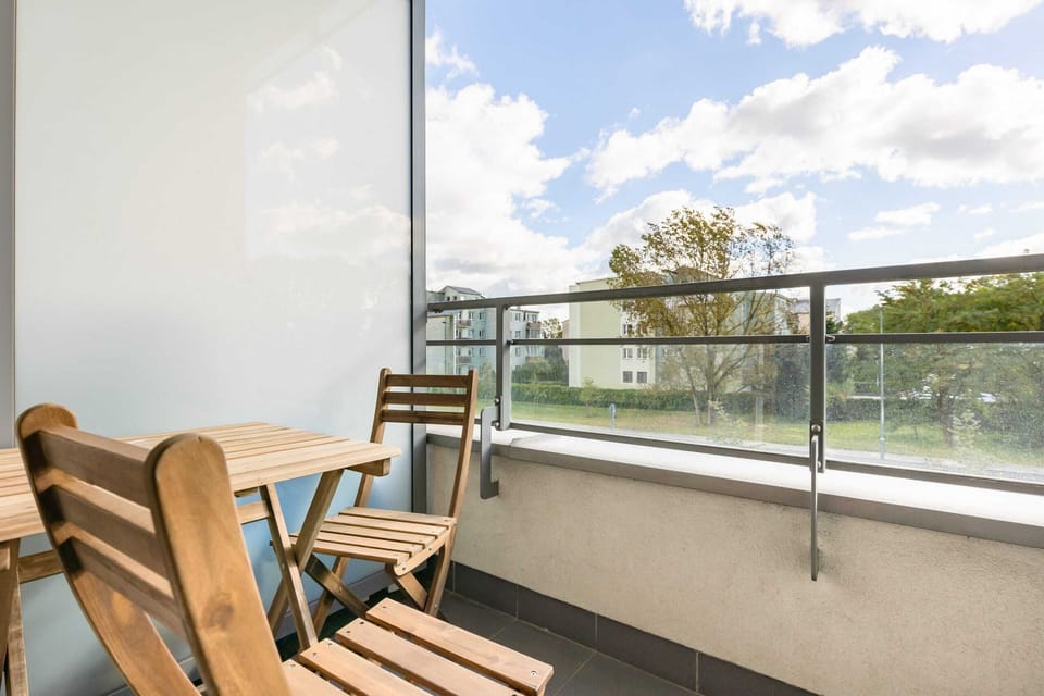 A private balcony with seating and a view, perfect for enjoying fresh air or morning coffee.

