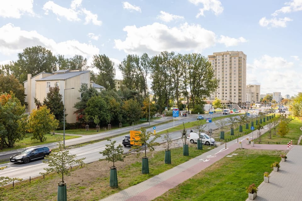 A scenic street view showcasing the nearby area with greenery and urban architecture.

