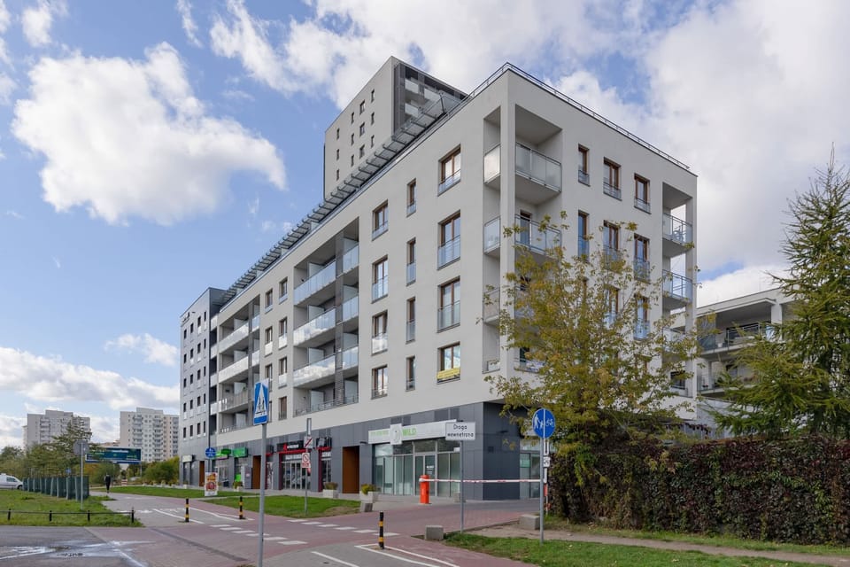 A view of the modern apartment building exterior, highlighting its clean design and welcoming surroundings.
