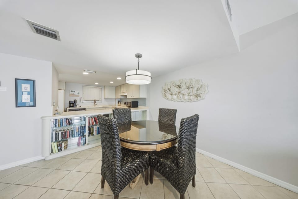 Conveniently located beside the kitchen, this dining area offers a comfortable space for shared meals and memorable gatherings.