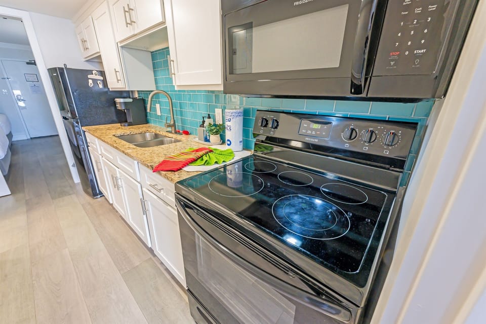 - Cook up something amazing in this vibrant, fully stocked kitchen - Sleek appliances, granite countertops, and a pop of color make this space shine - Whether it’s breakfast, dinner, or snacks in between, you’ll have everything you need