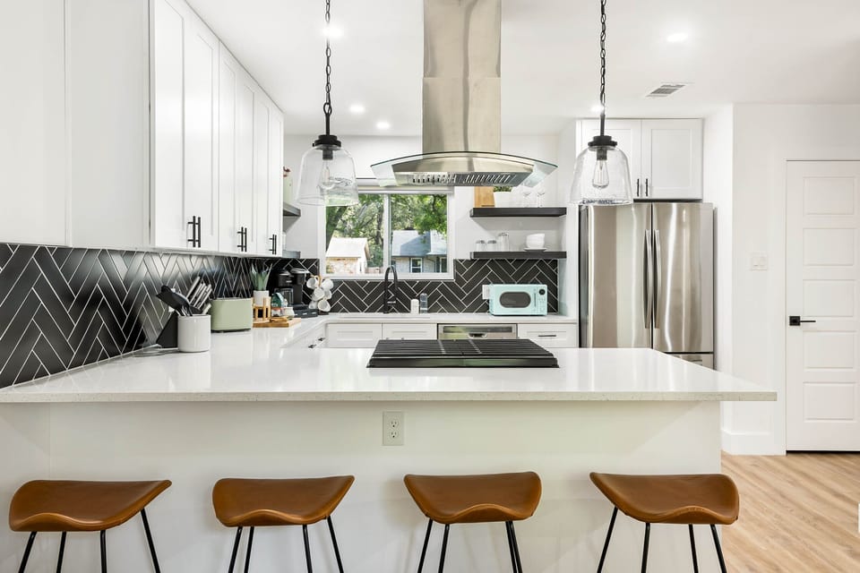 Spacious kitchen w/ ample counter space, high-top seating, and new appliances!