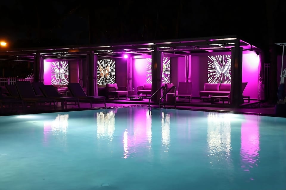 Enjoy vibrant nights with glowing cabanas beside the pool.