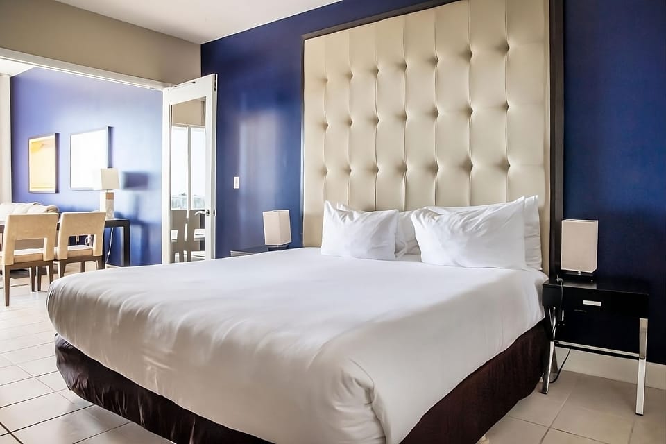 Sink into plush bedding beneath an oversized tufted headboard.
