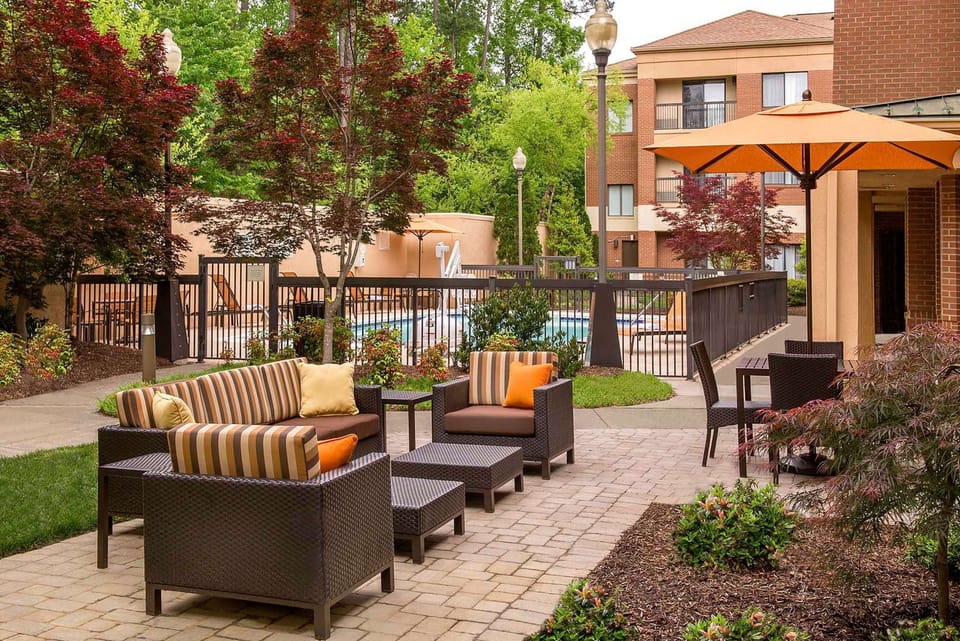 Unwind outdoors on cushioned seating beneath shady umbrellas.