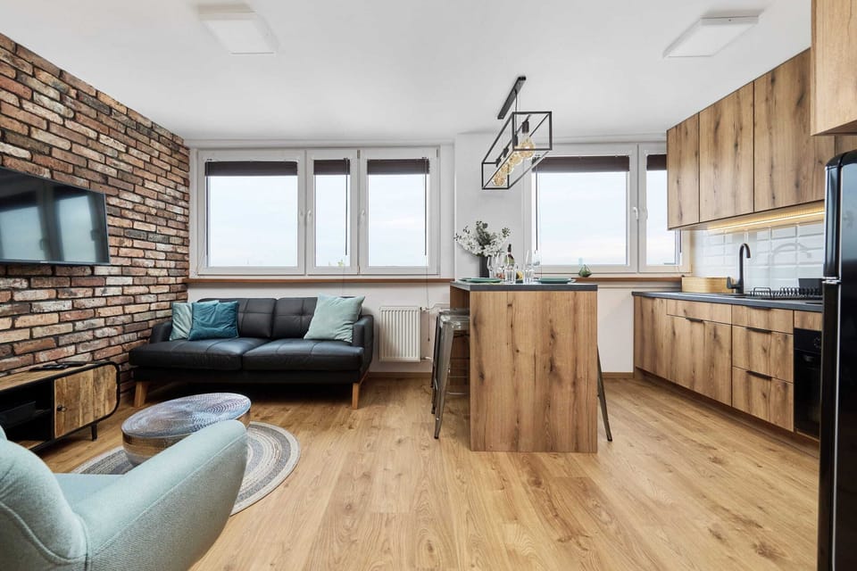 The open-plan living and kitchen space, blending modern and industrial styles harmoniously.
