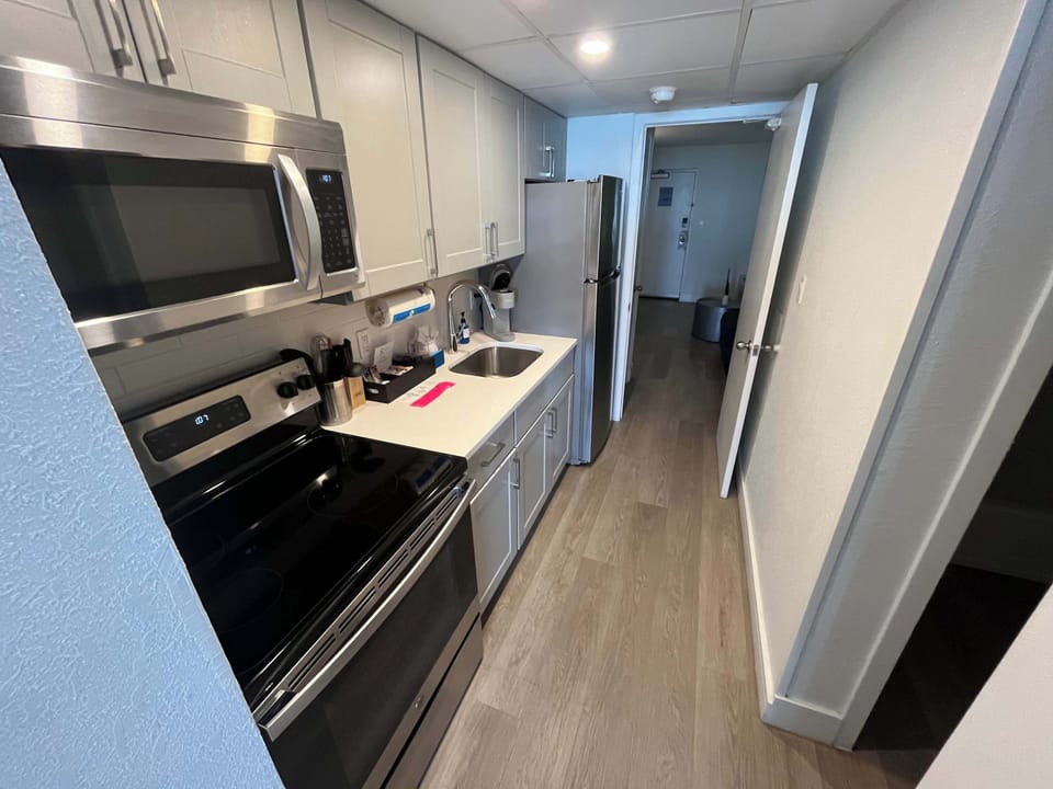 Enjoy the convenience of a fully equipped modern kitchen, complete with stainless steel appliances, sleek cabinetry, and all the essentials to prepare your favorite meals during your stay.