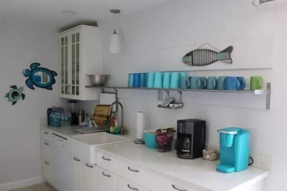 Ikea kitchen with farmhouse sink and coffee makings.