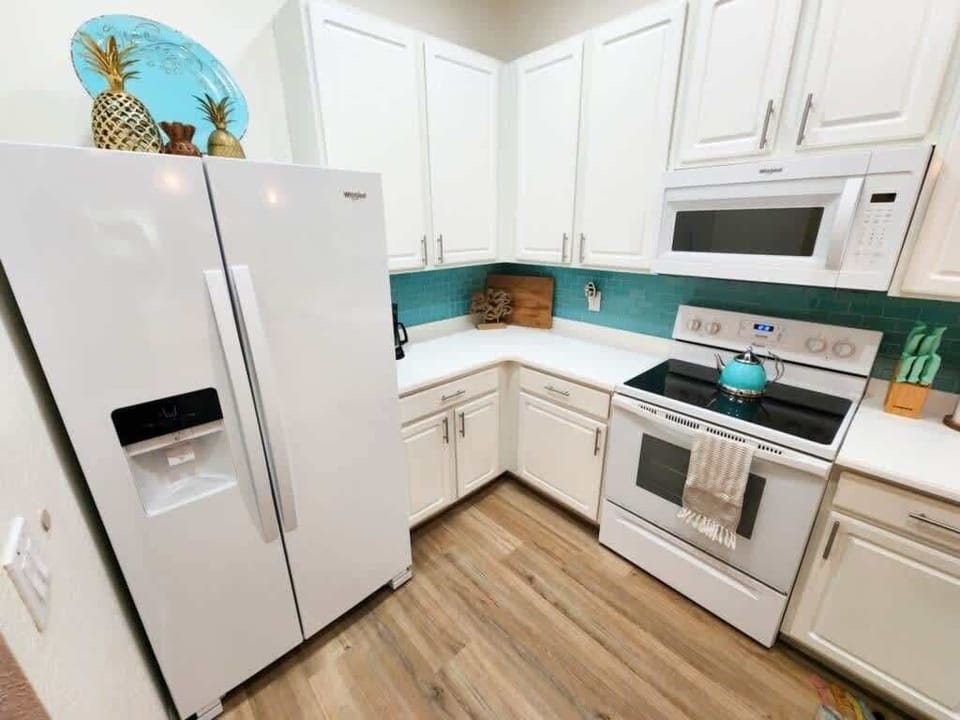 - Bright kitchen with full appliances storage and modern cooking setup
- Fully equipped kitchen ideal for home meals extended stays and families
- Clean functional kitchen supports easy vacation living  