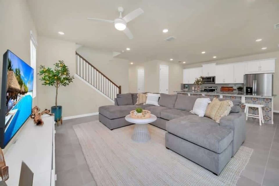 - Spacious lounge connects kitchen stairs and TV
- Open layout ideal for group time and movies
- Bright modern design for relaxing vacation days