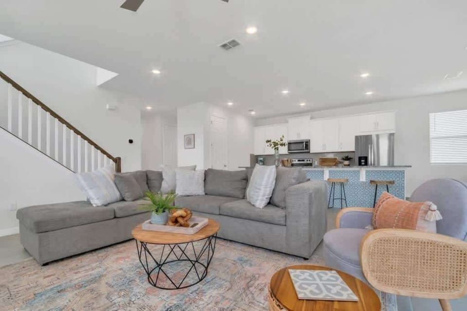 - Open living room with sectional sofa bright space for group stays
- Open plan lounge near kitchen perfect for family Airbnb rentals
- Modern vacation home living area with seating TV and comfort