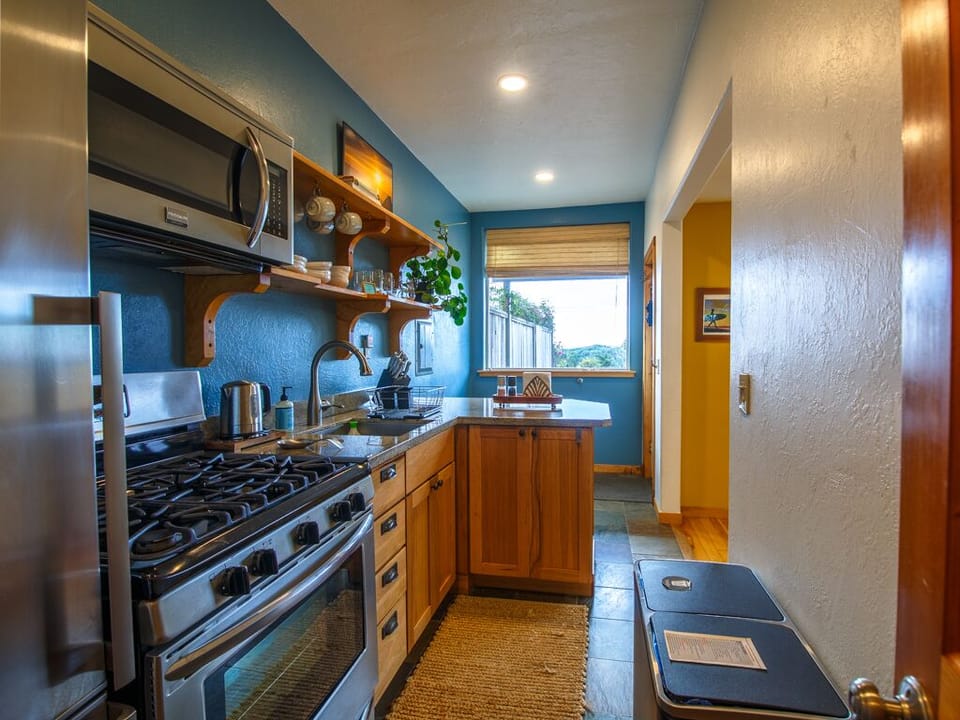 Kitchen has a window out to garden and distant ocean view on a clear day.