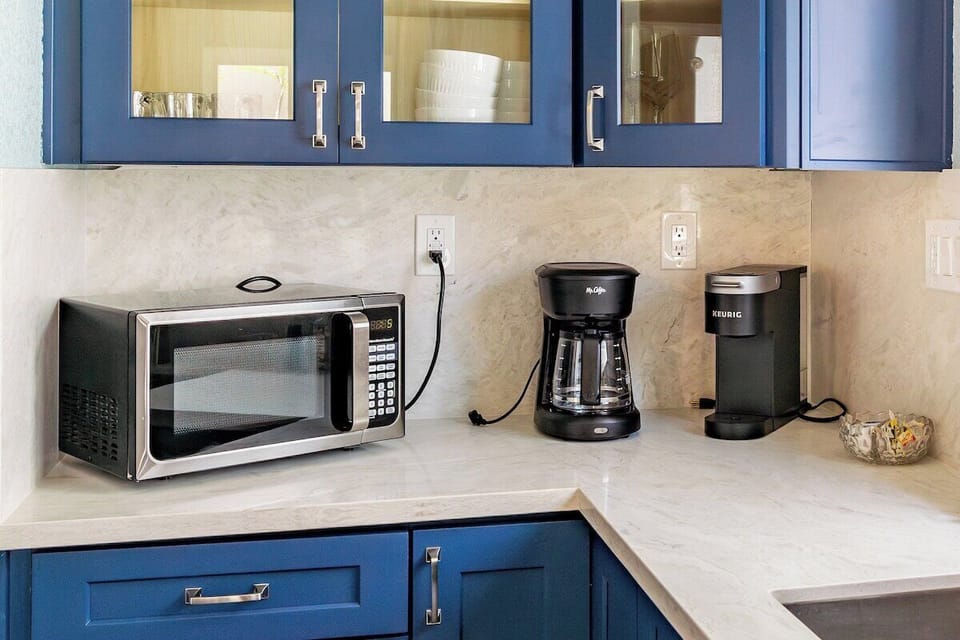 Appliances include a dishwasher, microwave, refrigerator and freezer, gas stove, oven, standard and Keurig coffee makers and toaster