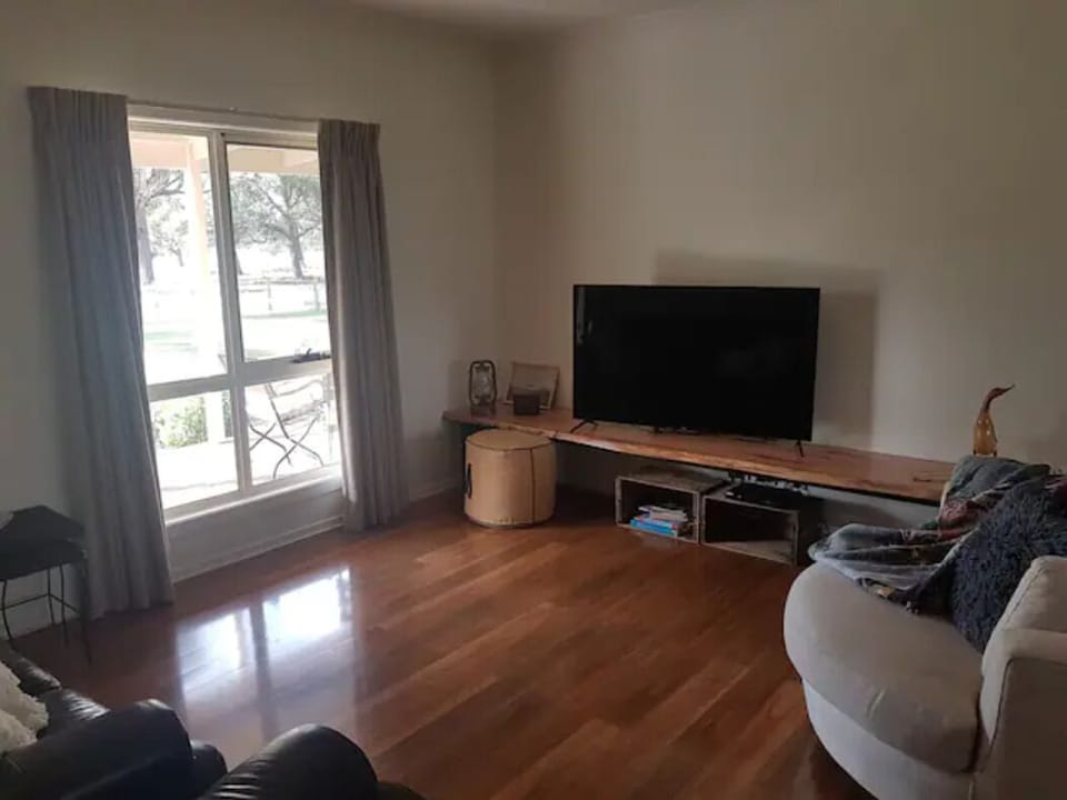 Main lounge with 55" Smart TV, 3 Seater leather lounge and arm chair, plus!