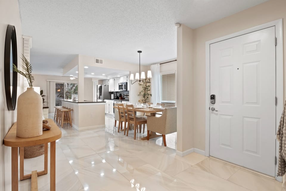 Open-concept with an island countertop and dining space for 6, designed for convenience and socializing.