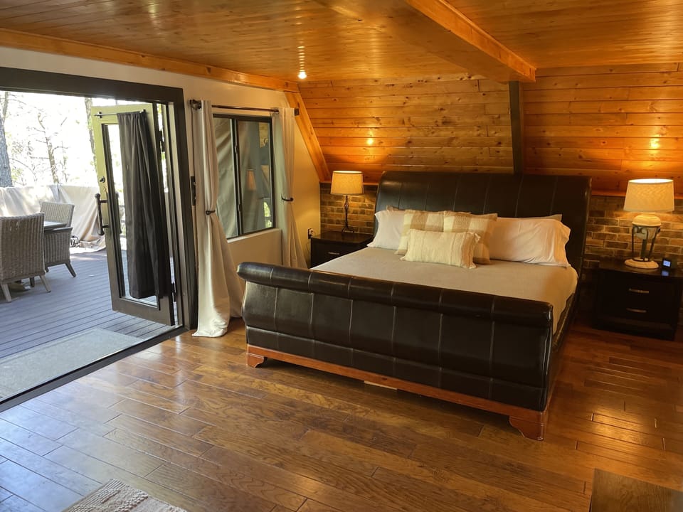 King size bed with walk out to back deck.