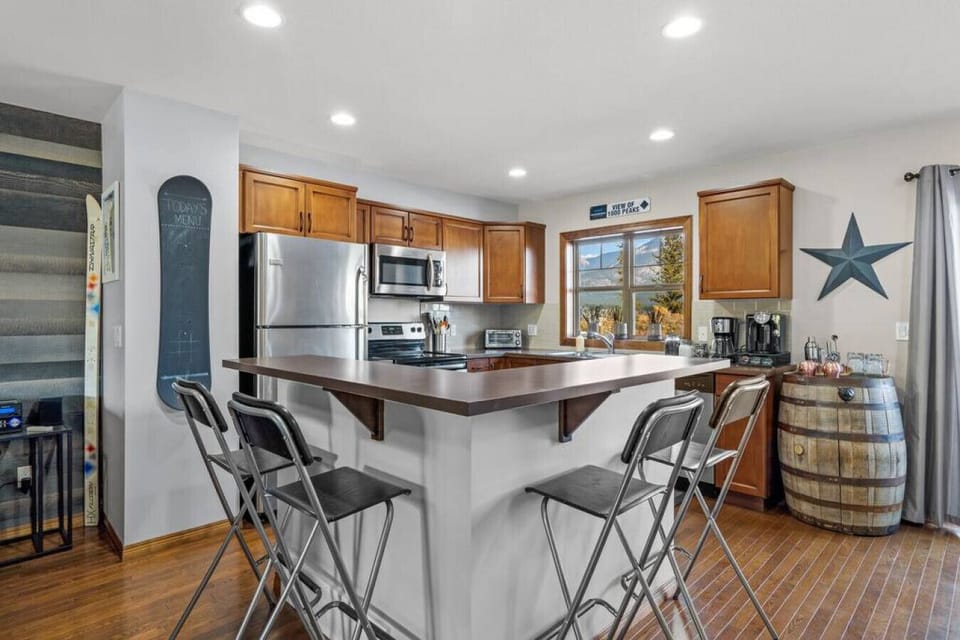 Dining area with seating for 6 at the table and 4 at the kitchen island.