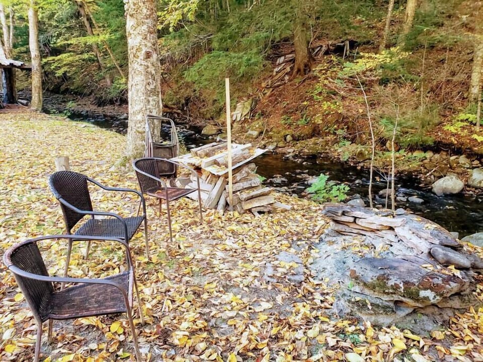 Fire pit near the brook to the right of the Lodge.