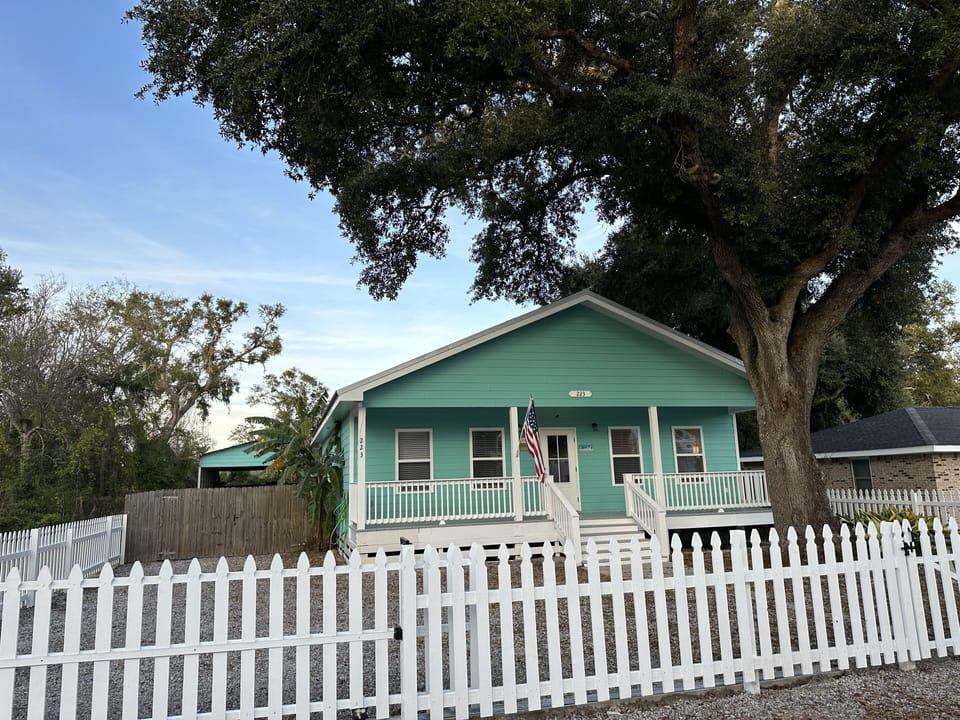 Rolling front gate for privacy allows multiple cars to park inside the gate.