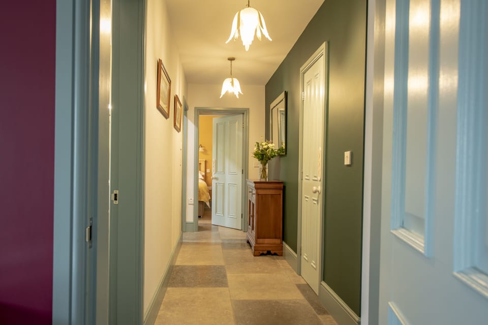 Ground floor: Hallway leading to all three bedrooms