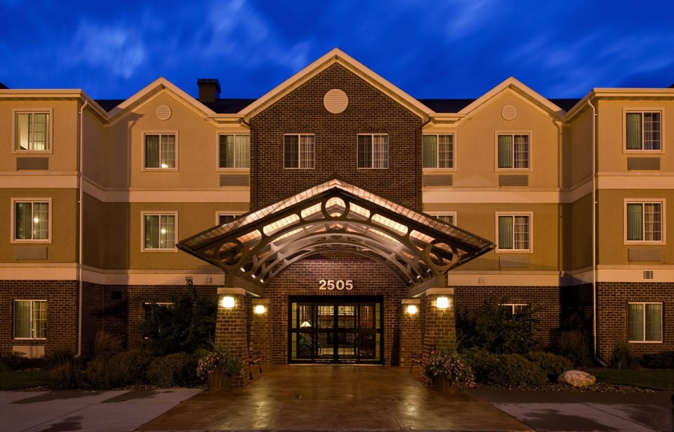 Building exterior illuminated at night, showcasing architectural details.