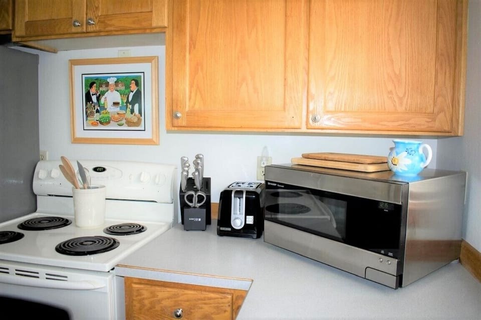 Full kitchen stocked with high end cutlery,  dishes, pots and pans 