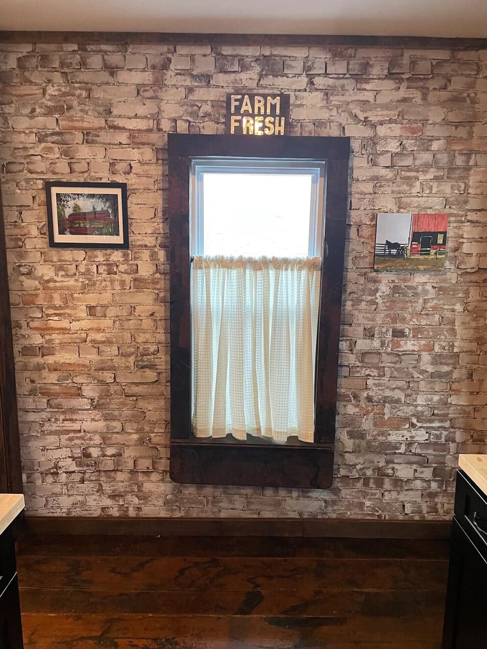 Kitchen area with original exposed bricks and hardwood floors.