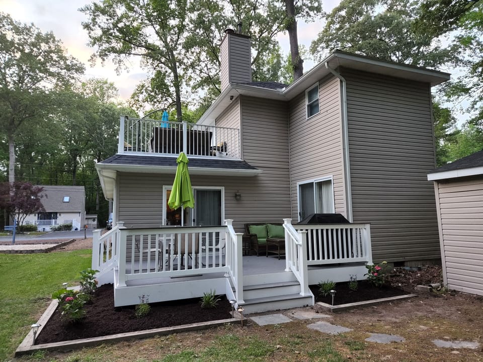 Back deck off the living room & back bedroom complete w/ dining area, gas grill.