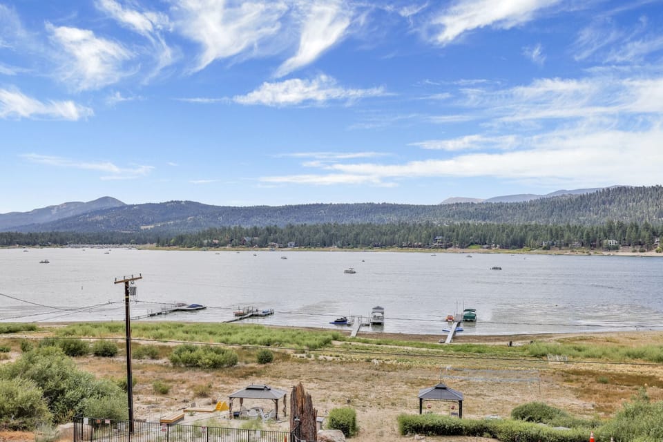 Spacious outdoor deck with beautiful lake and mountain views. Enjoy fresh air, comfortable seating, and a peaceful setting perfect for relaxing, dining, or watching the sunset over the water and surrounding nature.