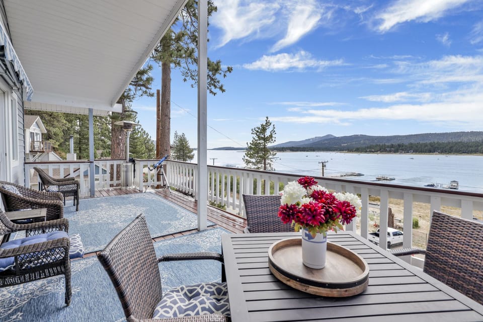 Spacious outdoor deck with beautiful lake and mountain views. Enjoy fresh air, comfortable seating, and a peaceful setting perfect for relaxing, dining, or watching the sunset over the water and surrounding nature.
