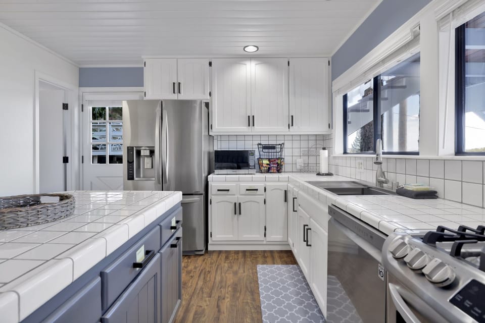 Fully equipped cabin kitchen with ample cabinetry, stove, fridge, microwave, and coffee maker—perfect for cooking meals, morning coffee, and feeling right at home on your stay.