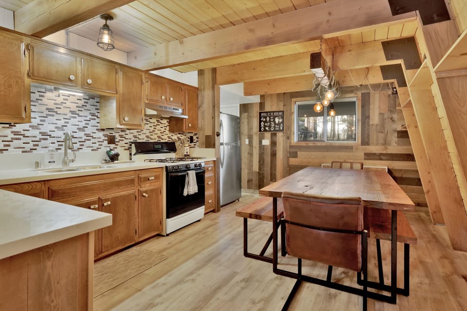 Fully equipped cabin kitchen with ample cabinetry, stove, fridge, microwave, and coffee maker—perfect for cooking meals, morning coffee, and feeling right at home on your stay.