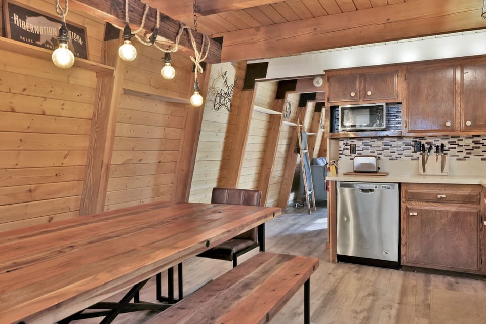 Fully equipped cabin kitchen with ample cabinetry, stove, fridge, microwave, and coffee maker—perfect for cooking meals, morning coffee, and feeling right at home on your stay.