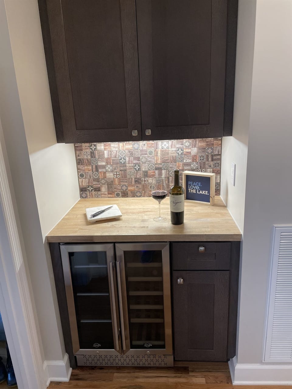 Newly added beverage center includes glasses, wine opener and other guest amenities.  Just off the kitchen and Mater Bedroom.